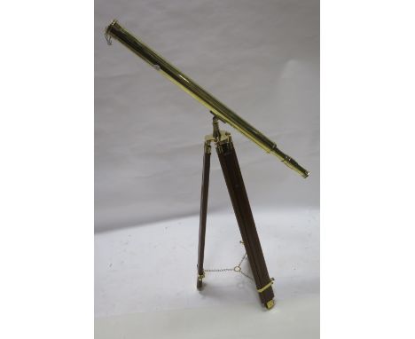 A BRASS TELESCOPE, on hardwood folding telescopic tripod,163cms high.