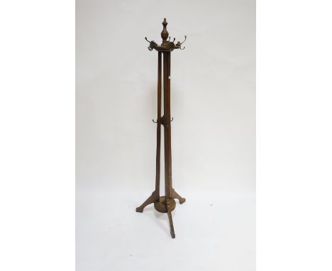 AN ARTS AND CRAFTS STYLE OAK FRAMED HALL STAND the circular reeded top with brass hooks on a tripod moulded frame with circul