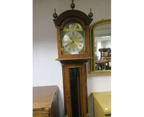 A MODERN MAHOGANY LONG CASE CLOCK the arched pediment headed by brass spheres above the silvered dial with black Roman numera