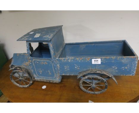 A TIN PLATE MODEL OF A VINTAGE TOY TRUCK, with spoke wheels,33cms x 66cms x 24cms