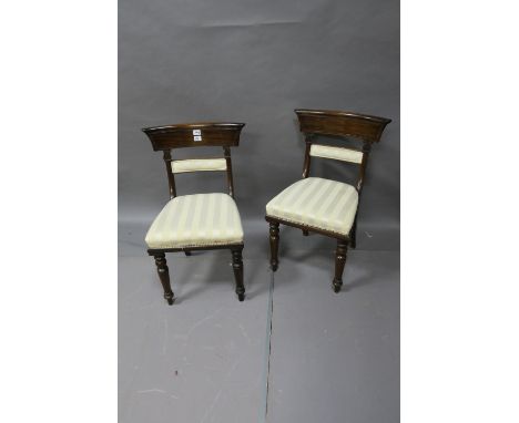 A PAIR OF REGENCY ROSEWOOD DINING ROOM CHAIRS the slightly bowed backs with upholstered panel between shaped supports headed 