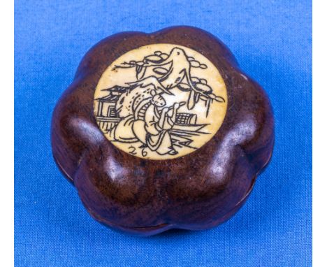 A Chinese carved nut compass