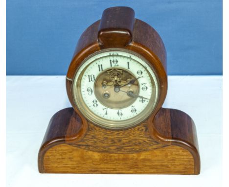 An oak mantel clock with enamel dial and open escapement 