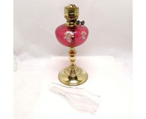 Antique brass oil lamp with cranberry glass reservoir with enamel flower decoration - total height 63cm &amp; slight dent to 