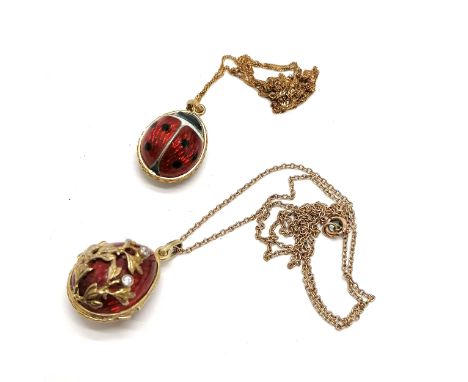 2 x unmarked enamel pendants (ladybird &amp; egg locket pendant - a/f on reverse) both on 9ct marked gold 42cm chains ~ total