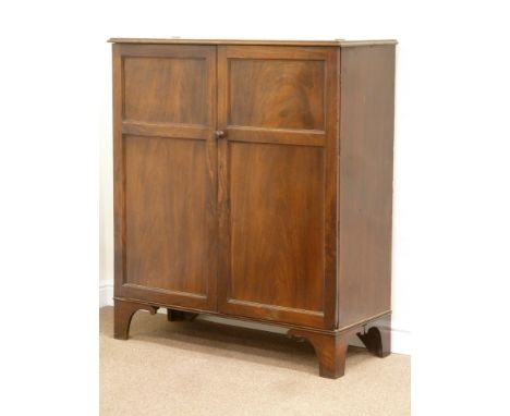 Georgian figured mahogany two door cupboard fitted with shelves, raised on bracket feet, W111cm, H127cm, D46cm