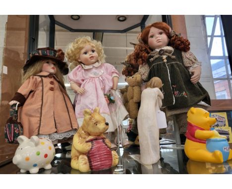 Three modern bisque dolls on stands, Charpente ceramic Winnie the Pooh, plaster Winnie the pooh, Demdaco 'Chrysalis' figure g