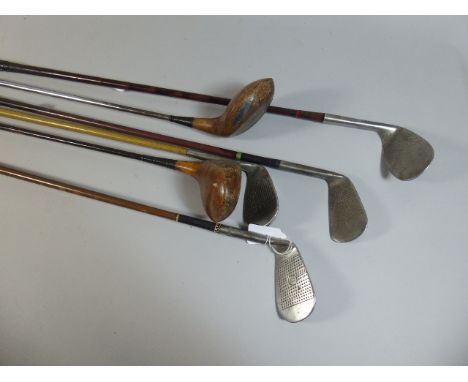 A Collection of Four Vintage Golfing Irons and Two Vintage Drivers