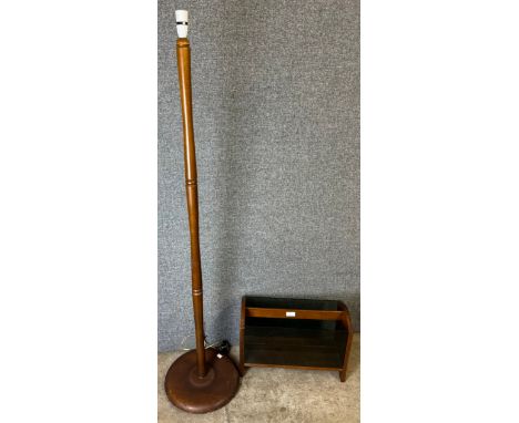 A teak and glass magazine rack and a standard lamp 