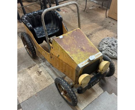A vintage child's toy pedal car 