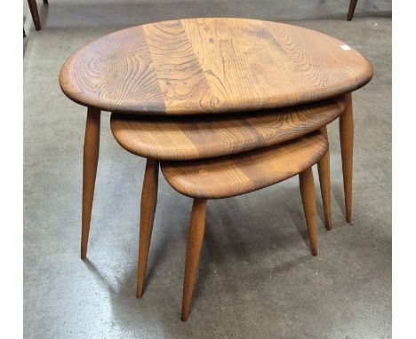 An Ercol elm and beech pebble shaped nest of tables 
