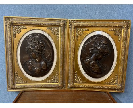 A pair of 19th Century style bronze effect oval plaques, portrait of lady's, gilt frames 