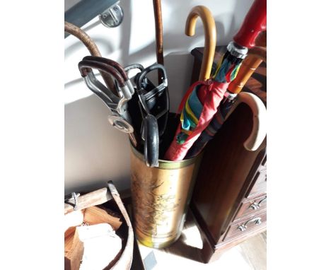 A stick stand and contents including two shooting sticks, four umbrellas and four walking sticks. 