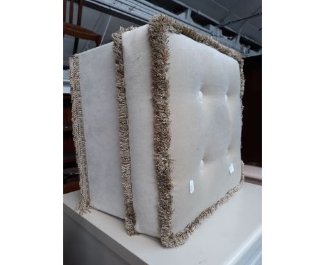 An upholstered pouffe. 