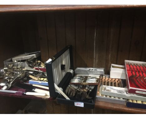 Shelf of boxed and other plated cutlery 