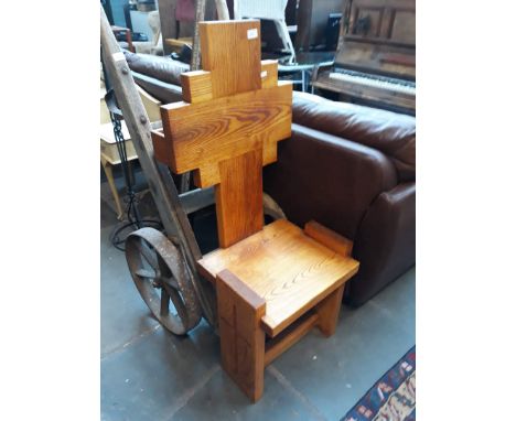 An ecclesiastical light oak chair. 