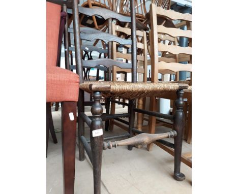 A pair of oak rush seat ladder back chairs. 