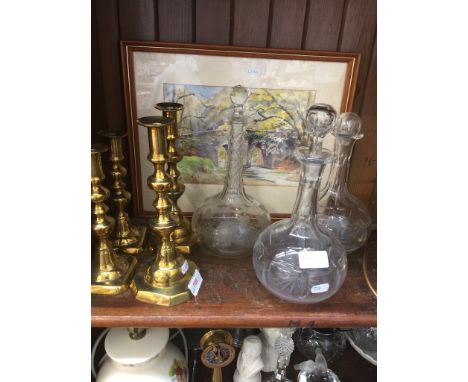 Four brass candlesticks and three glass decantersCondition: Split to one smaller candle stick, 1 stopper damaged, no other da