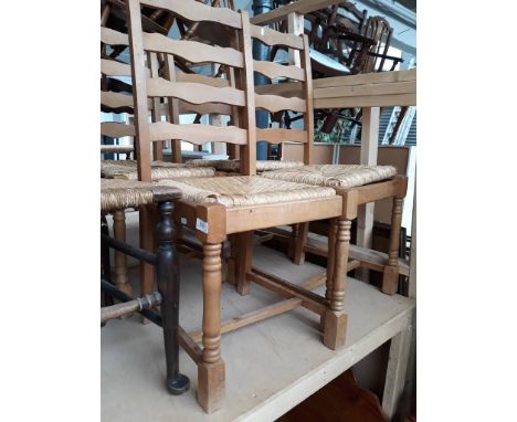 A set of four ladder back chairs with rush seats. 