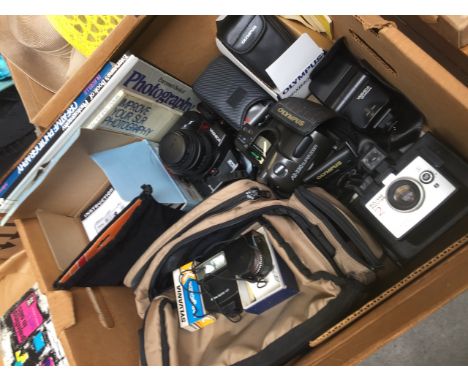 A box of cameras and camera accessories 