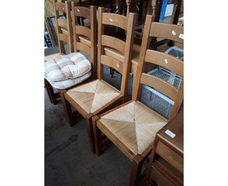 A set of 4 pine ladder back rush seat chairs 