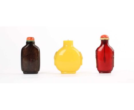 Three Chinese Snuff Bottles Three Chinese Snuff Bottles, late Qing, comprising a Peking-type yellow glass bottle bearing taot