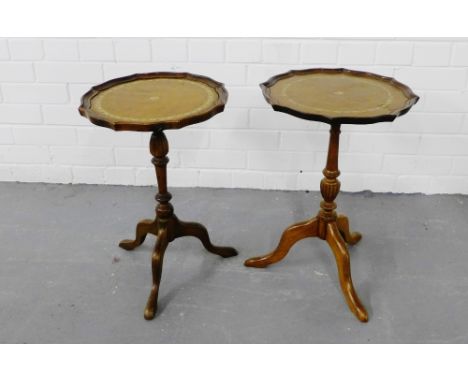 Two mahogany wine tables, the pie crust tray tops with brown leather skivers on tripod supports, (2) 