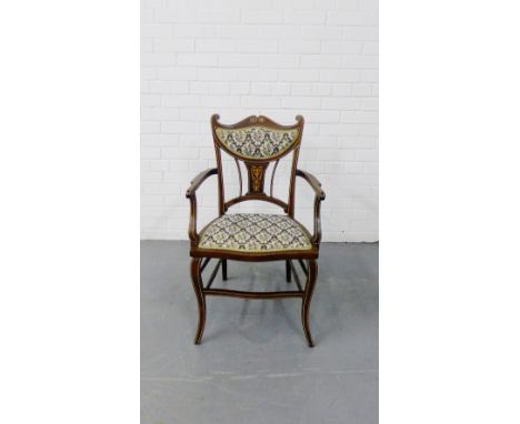 An Edwardian inlaid mahogany open armchair, the shaped back with an inlaid splat below an upholstered panel, with an upholste