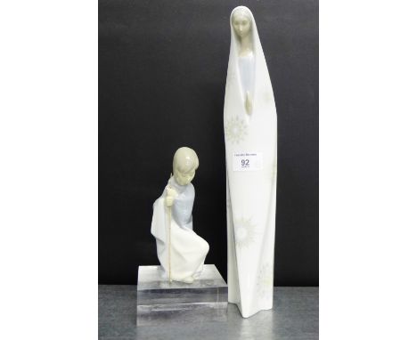 A Lladro figure of a boy in a cloak, modelled kneeling, together with a Lladro style figure of a female figure, modelled in p