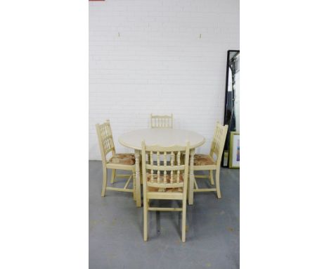 A contemporary light oak five piece dining set retailed by Martin & Frost, comprising circular topped table and four spindle 