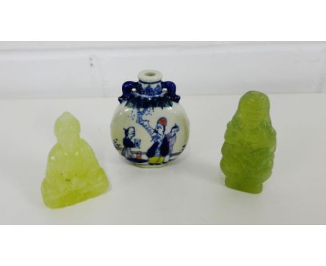 Two Chinese green jade carvings, one of a Buddha, the other a female figure, together with a blue and white figural painted s
