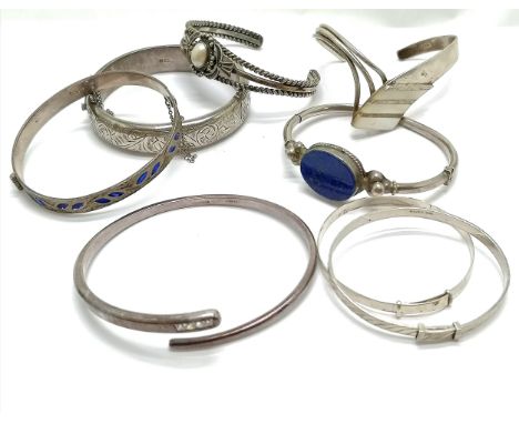 8 x silver bangles inc Navajo D Reeves, 'Always watching over you' (unmarked silver), lapis panel, engraved bangle (has sligh