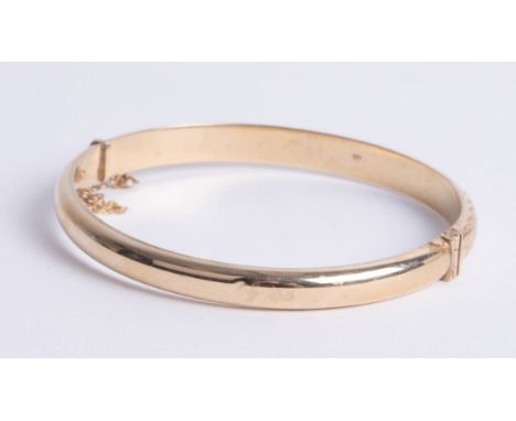 A 9ct gold bangle, makers mark 'DLM', approx 8.80g.