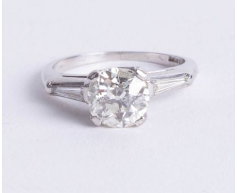 A fine platinum diamond solitaire ring, the centre old cut diamond approx 2 carats, two further diamonds set to the shoulders