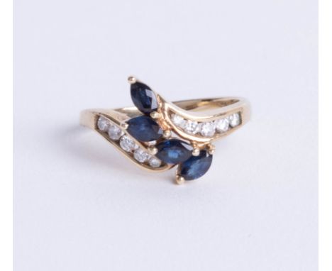 A 9ct sapphire and diamond set ring, set with four royal blue marquise cut sapphires with central twist, size K.