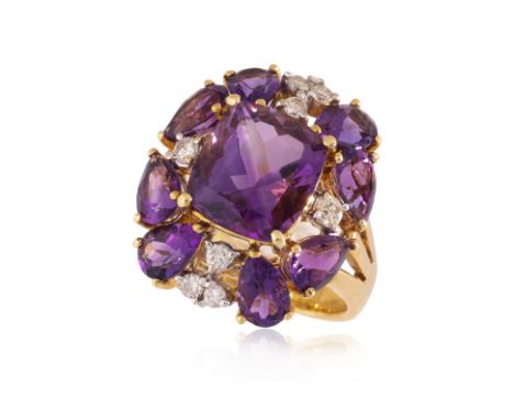 AN AMETHYST AND DIAMOND RING
Featuring a cushion shaped amethyst surrounded by multi pearl shaped amethysts, totalling approx
