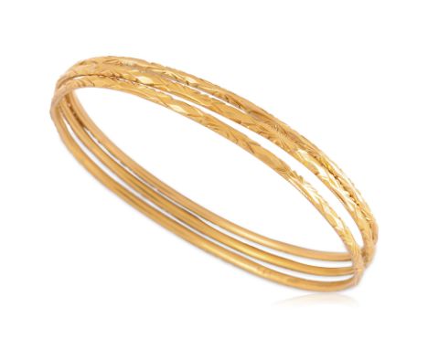 A GROUP OF THREE GOLD BANGLES
To include a pair of high karat gold bangles, each marked '22' for 22K among other marks, accom