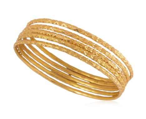 A GROUP OF FIVE HIGH KARAT GOLD BANGLES
Featuring a group of five high karat gold bangles each marked '22K', alongside variou