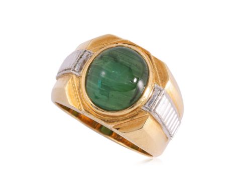 A CAT'S EYE TOURMALINE TWO TONE RING
Featuring a green cat's eye tourmaline weighing approximately 4.90 Cts, mounted in a two