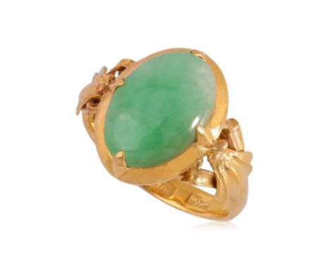 A TYPE A JADEITE AND HIGH KARAT GOLD RING Featuring a type a jadeite cabochon of light green to green colour, mounted in a ye