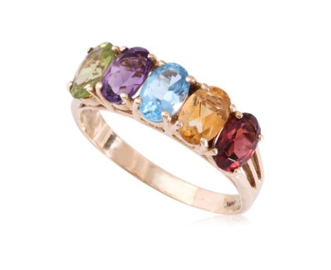 A MULTI-GEM FIVE STONE RING
Featuring five oval shaped semi precious gems to include garnet, blue topaz, citrine, amethyst an