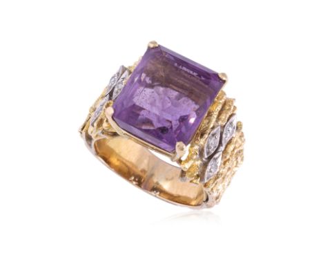 AN AMETHYST AND DIAMOND 'BARK EFFECT' RING
Featuring an emerald cut amethyst weighing approximately 5.50 Cts, mounted in an u