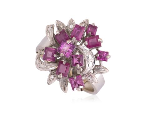 A SYNTHETIC RUBY RING
Featuring synthetic baguette cut rubies mounted in a white gold setting marked '18K', with a ring sizer