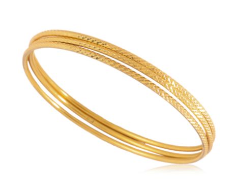 A GROUP OF THREE HIGH KARAT GOLD BANGLES
Featuring a group of three high karat gold bangles marked '916' for 22K.
Inner diame