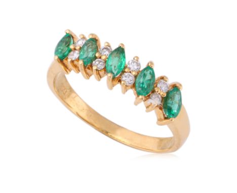 AN EMERALD AND DIAMOND HIGH KARAT GOLD RING
Featuring marquise shaped emeralds totalling approximately 0.40 Cts, mounted in a