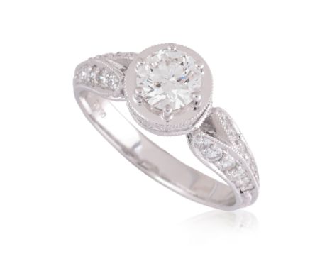 A DIAMOND 'MILGRAIN' RING BY LARRY JEWELRY
Featuring a round brilliant cut diamond weighing approximately 0.60 Cts, mounted i