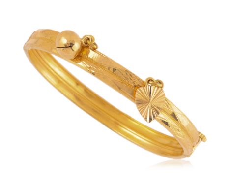 A GOLD CHARM BANGLE
Featuring a gold charm bangle with two charms, screw hinged, marked with Chinese gold mark.
Inner measure