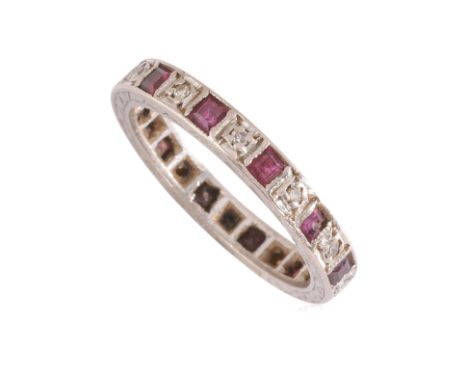A RUBY AND DIAMOND ETERNITY RING
Featuring square cut rubies accented with single cut diamonds mounted in a white metal setti