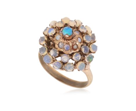 AN OPAL AND MOONSTONE RING
Featuring opal and moonstone cabochons mounted in a yellow gold setting marked '14K'.
US Size 6
3.