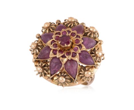 AN INDIAN STYLE RUBY 'FLOWER' RING
Featuring round cut and pear cabochon rubies totalling approximately 8.0 Cts, mounted in a